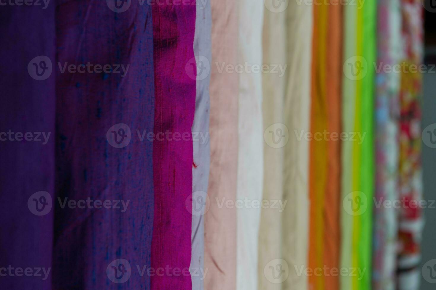 Collection of fashionable fabrics. Samples of different natural fabrics for sewing a fashion collection of clothes. Large selection of fabrics in the store or tailor warehouse. photo