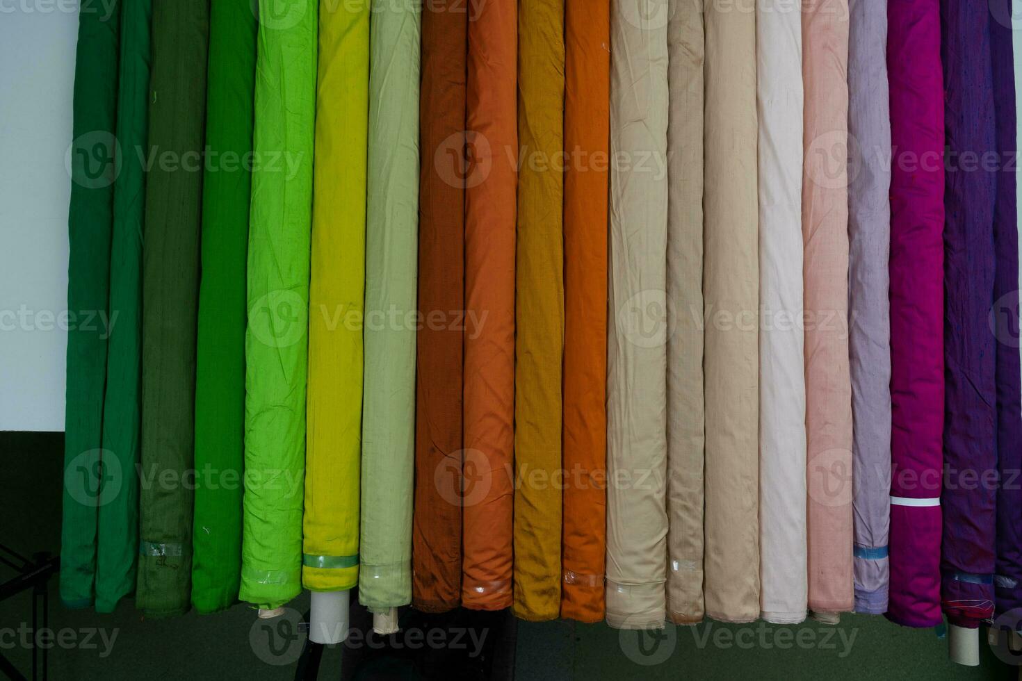 Collection of fashionable fabrics. Samples of different natural fabrics for sewing a fashion collection of clothes. Large selection of fabrics in the store or tailor warehouse. photo