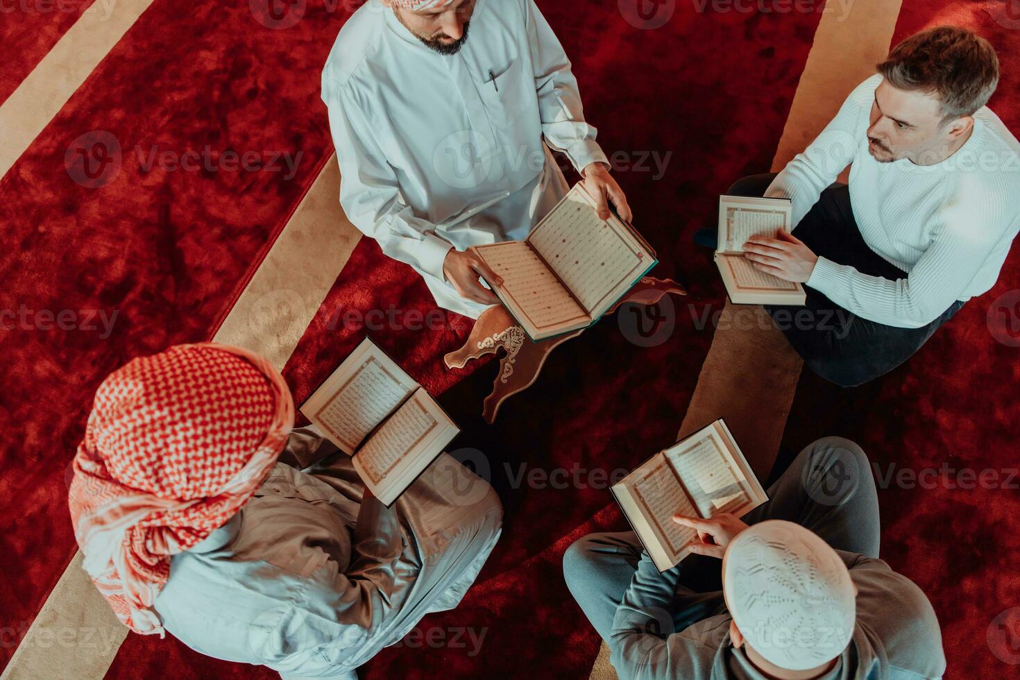 A group of Muslims reading the holy book of the Quran in a modern mosque during the Muslim holiday of Ramadan photo