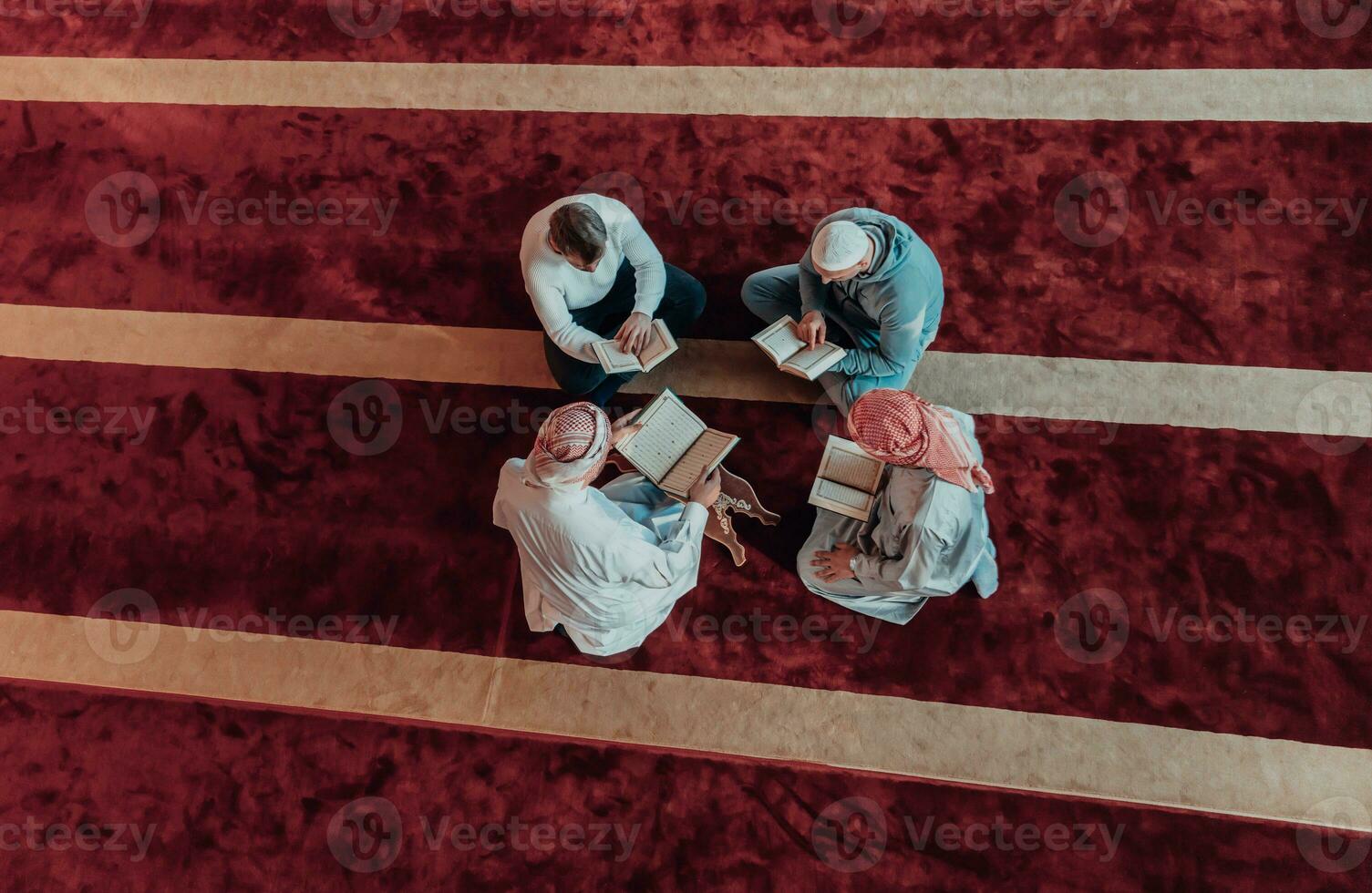 A group of Muslims reading the holy book of the Quran in a modern mosque during the Muslim holiday of Ramadan photo