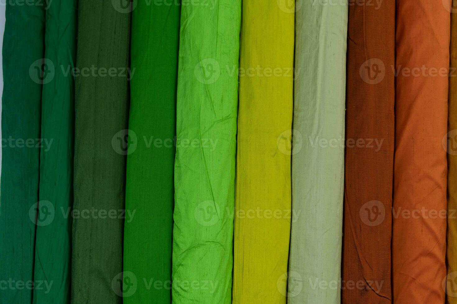 Collection of fashionable fabrics. Samples of different natural fabrics for sewing a fashion collection of clothes. Large selection of fabrics in the store or tailor warehouse. photo