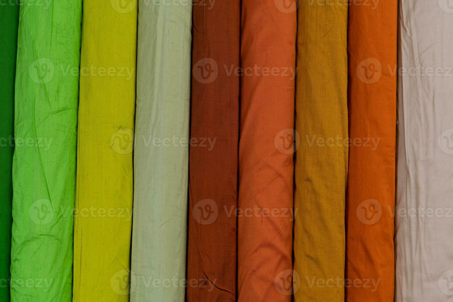 Collection of fashionable fabrics. Samples of different natural fabrics for sewing a fashion collection of clothes. Large selection of fabrics in the store or tailor warehouse. photo