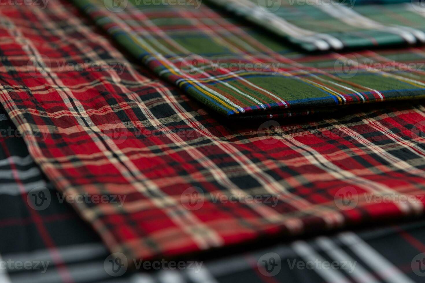 Collection of Scottish fashionable fabrics . Samples of different natural fabrics for sewing a fashion collection of clothes. Large selection of fabrics in the store or tailor warehouse. photo