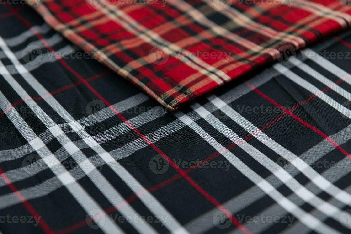 Collection of Scottish fashionable fabrics . Samples of different natural fabrics for sewing a fashion collection of clothes. Large selection of fabrics in the store or tailor warehouse. photo