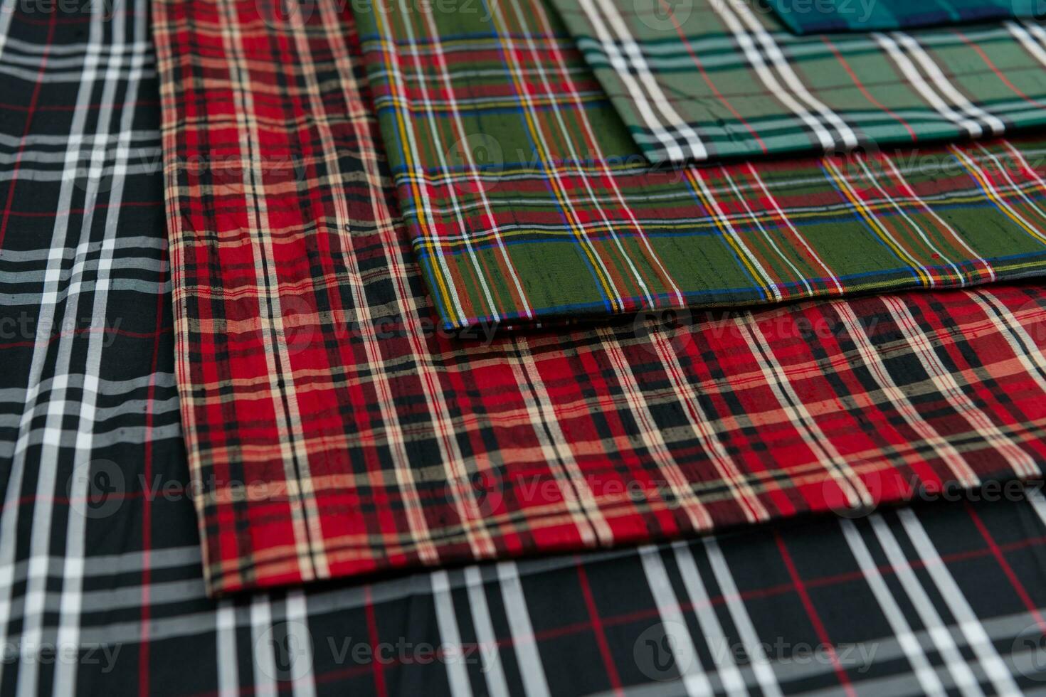Collection of Scottish fashionable fabrics . Samples of different natural fabrics for sewing a fashion collection of clothes. Large selection of fabrics in the store or tailor warehouse. photo