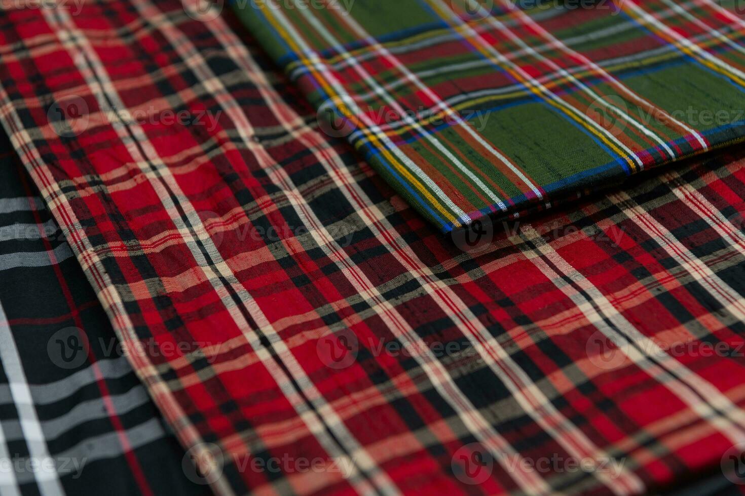 Collection of Scottish fashionable fabrics . Samples of different natural fabrics for sewing a fashion collection of clothes. Large selection of fabrics in the store or tailor warehouse. photo