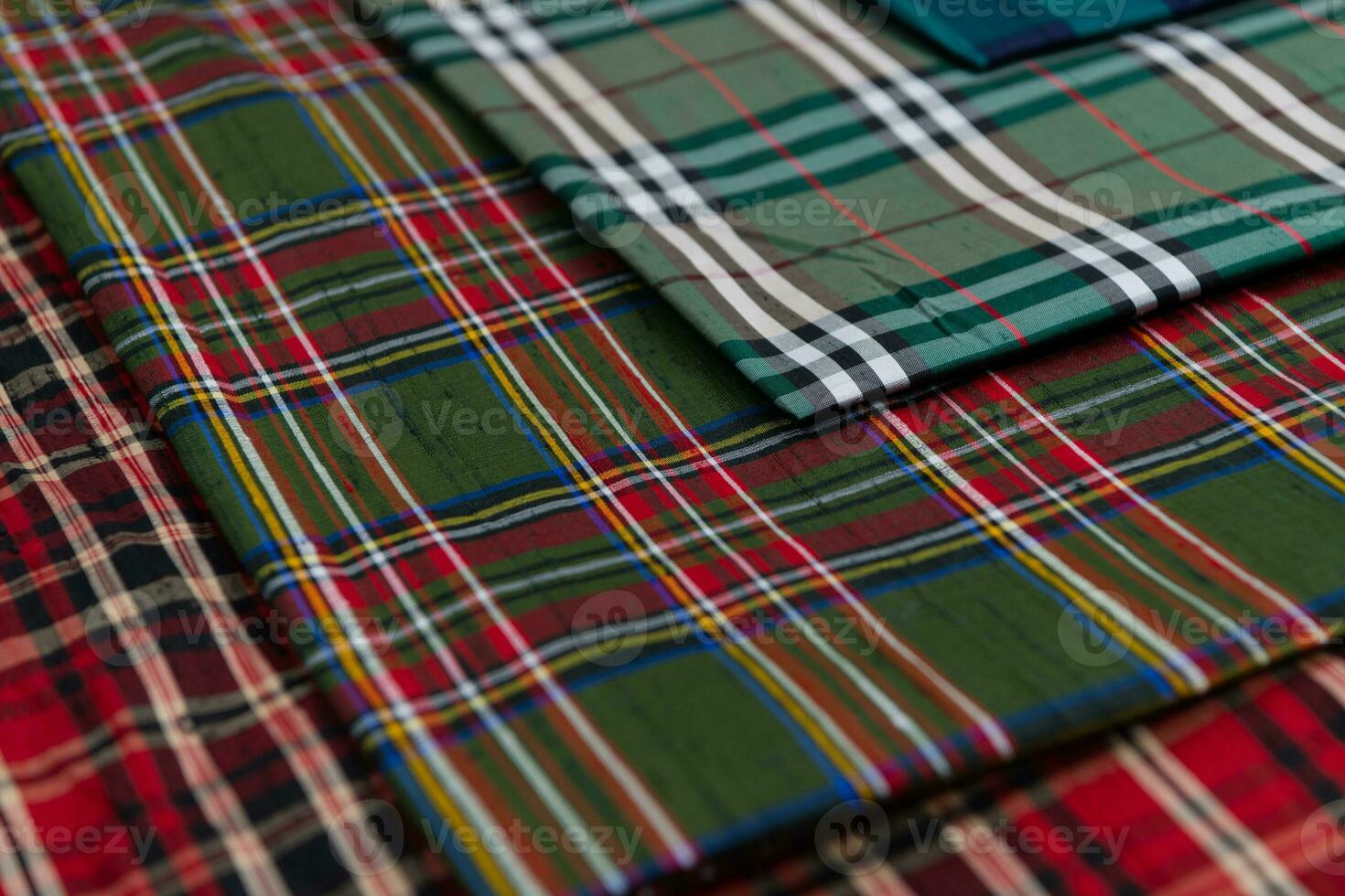 Collection of Scottish fashionable fabrics . Samples of different natural fabrics for sewing a fashion collection of clothes. Large selection of fabrics in the store or tailor warehouse. photo