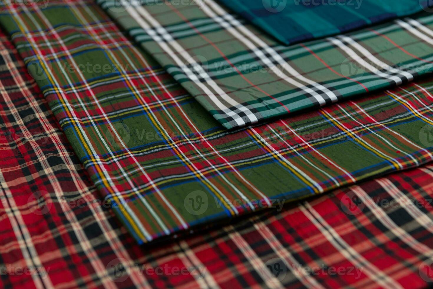 Collection of Scottish fashionable fabrics . Samples of different natural fabrics for sewing a fashion collection of clothes. Large selection of fabrics in the store or tailor warehouse. photo
