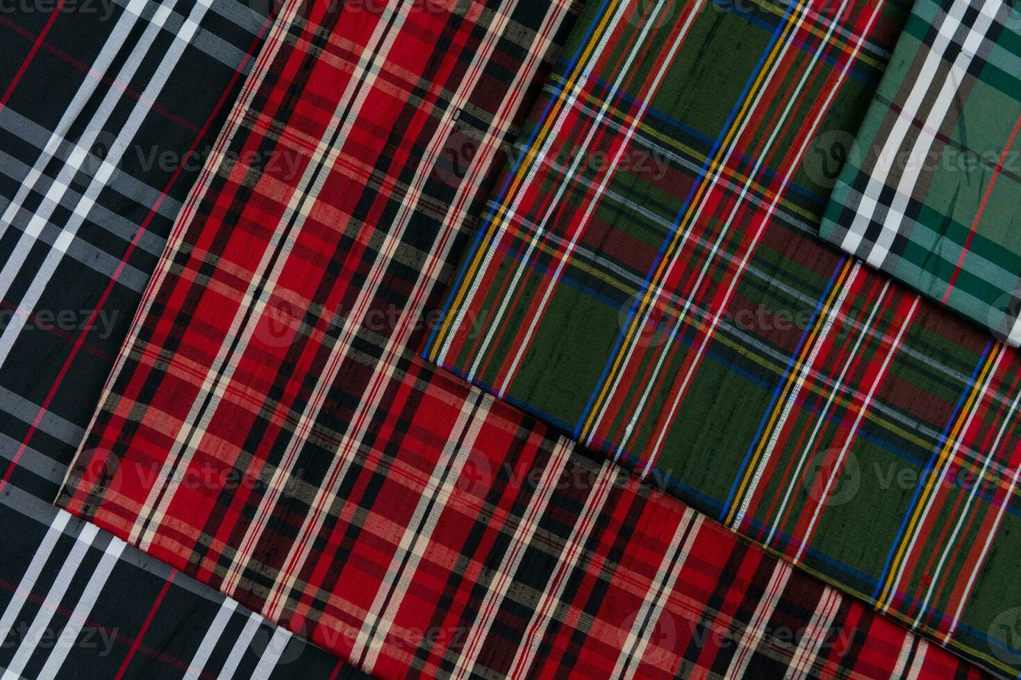 Collection of Scottish fashionable fabrics . Samples of different natural fabrics for sewing a fashion collection of clothes. Large selection of fabrics in the store or tailor warehouse. photo
