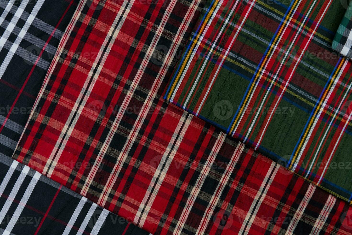 Collection of Scottish fashionable fabrics . Samples of different natural fabrics for sewing a fashion collection of clothes. Large selection of fabrics in the store or tailor warehouse. photo