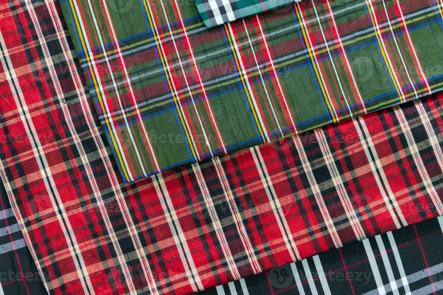 Collection of Scottish fashionable fabrics . Samples of different natural fabrics for sewing a fashion collection of clothes. Large selection of fabrics in the store or tailor warehouse. photo
