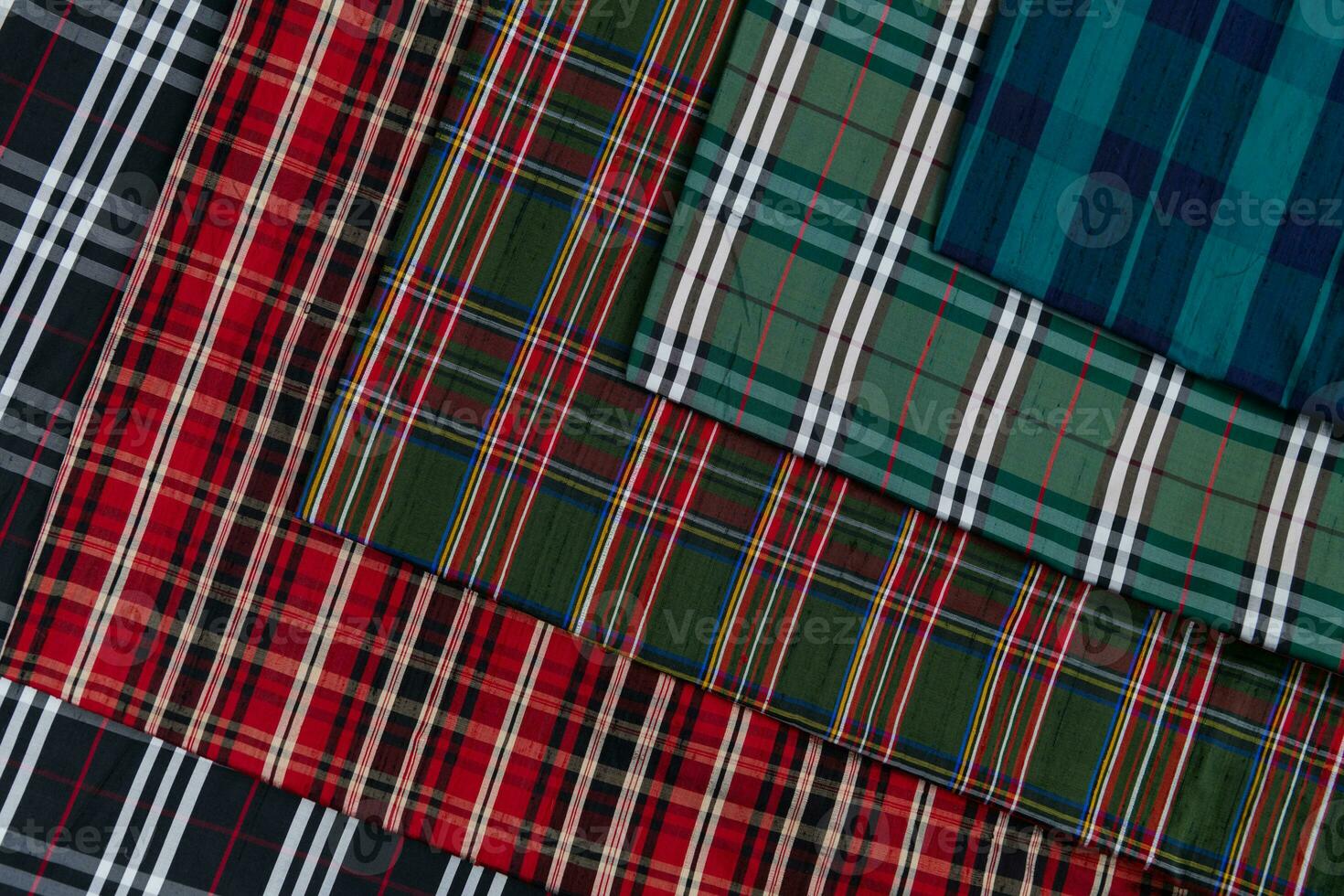 Collection of Scottish fashionable fabrics . Samples of different natural fabrics for sewing a fashion collection of clothes. Large selection of fabrics in the store or tailor warehouse. photo