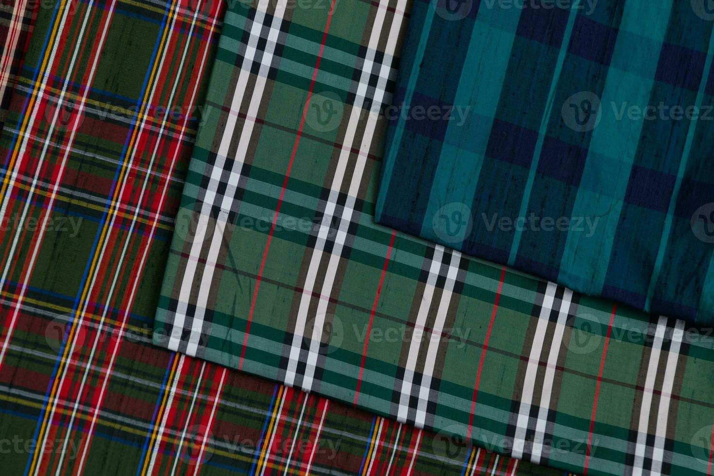 Collection of Scottish fashionable fabrics . Samples of different natural fabrics for sewing a fashion collection of clothes. Large selection of fabrics in the store or tailor warehouse. photo