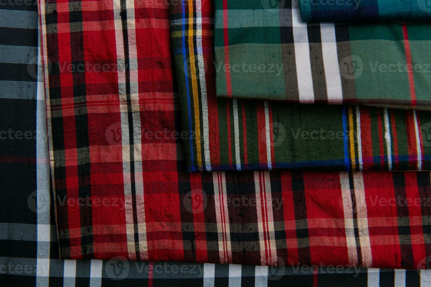 Collection of Scottish fashionable fabrics . Samples of different natural fabrics for sewing a fashion collection of clothes. Large selection of fabrics in the store or tailor warehouse. photo
