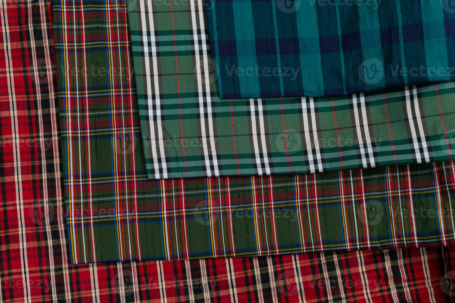 Collection of Scottish fashionable fabrics . Samples of different natural fabrics for sewing a fashion collection of clothes. Large selection of fabrics in the store or tailor warehouse. photo