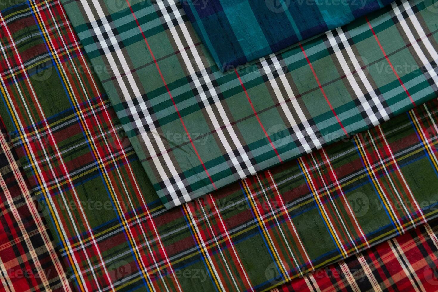 Collection of Scottish fashionable fabrics . Samples of different natural fabrics for sewing a fashion collection of clothes. Large selection of fabrics in the store or tailor warehouse. photo