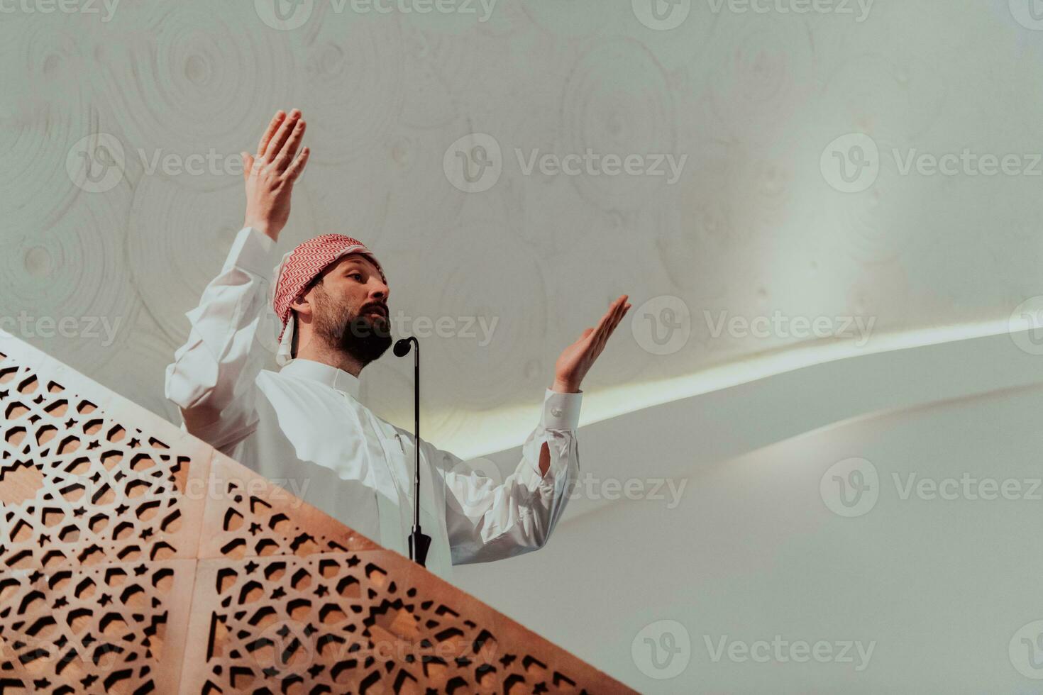 Muslims arabic Imam has a speech on friday afternoon prayer in mosque. Muslims have gathered for the friday afternoon prayer in mosque and are listening to the speech of imam photo