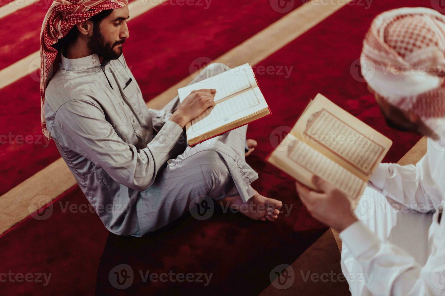 A group of Muslims reading the holy book of the Quran in a modern mosque during the Muslim holiday of Ramadan photo