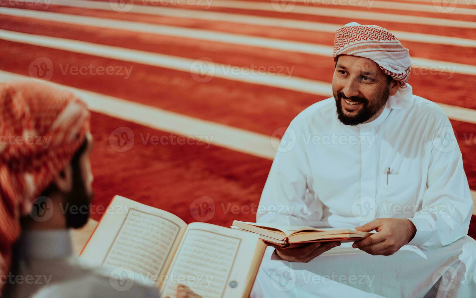 A group of Muslims reading the holy book of the Quran in a modern mosque during the Muslim holiday of Ramadan photo
