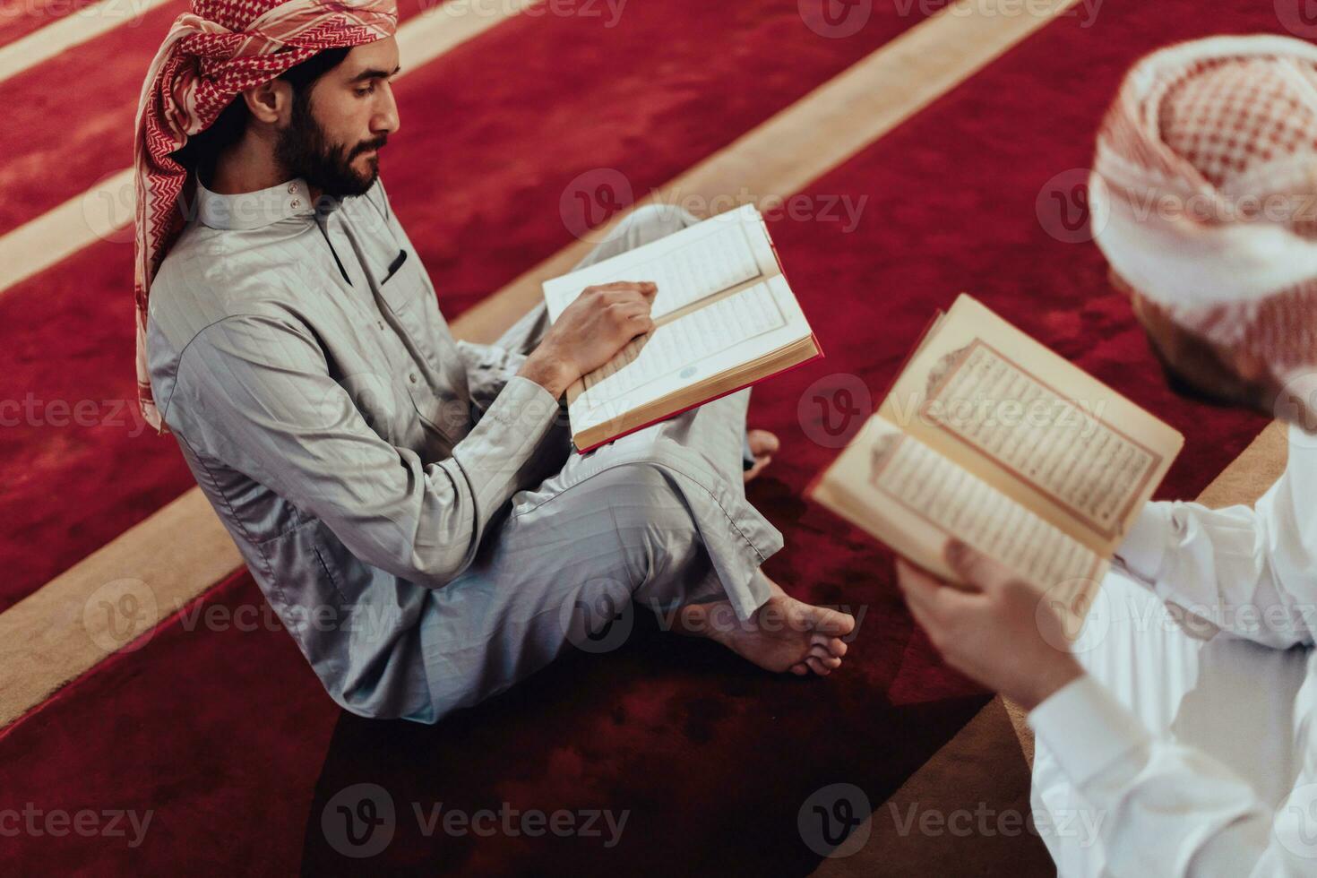 A group of Muslims reading the holy book of the Quran in a modern mosque during the Muslim holiday of Ramadan photo