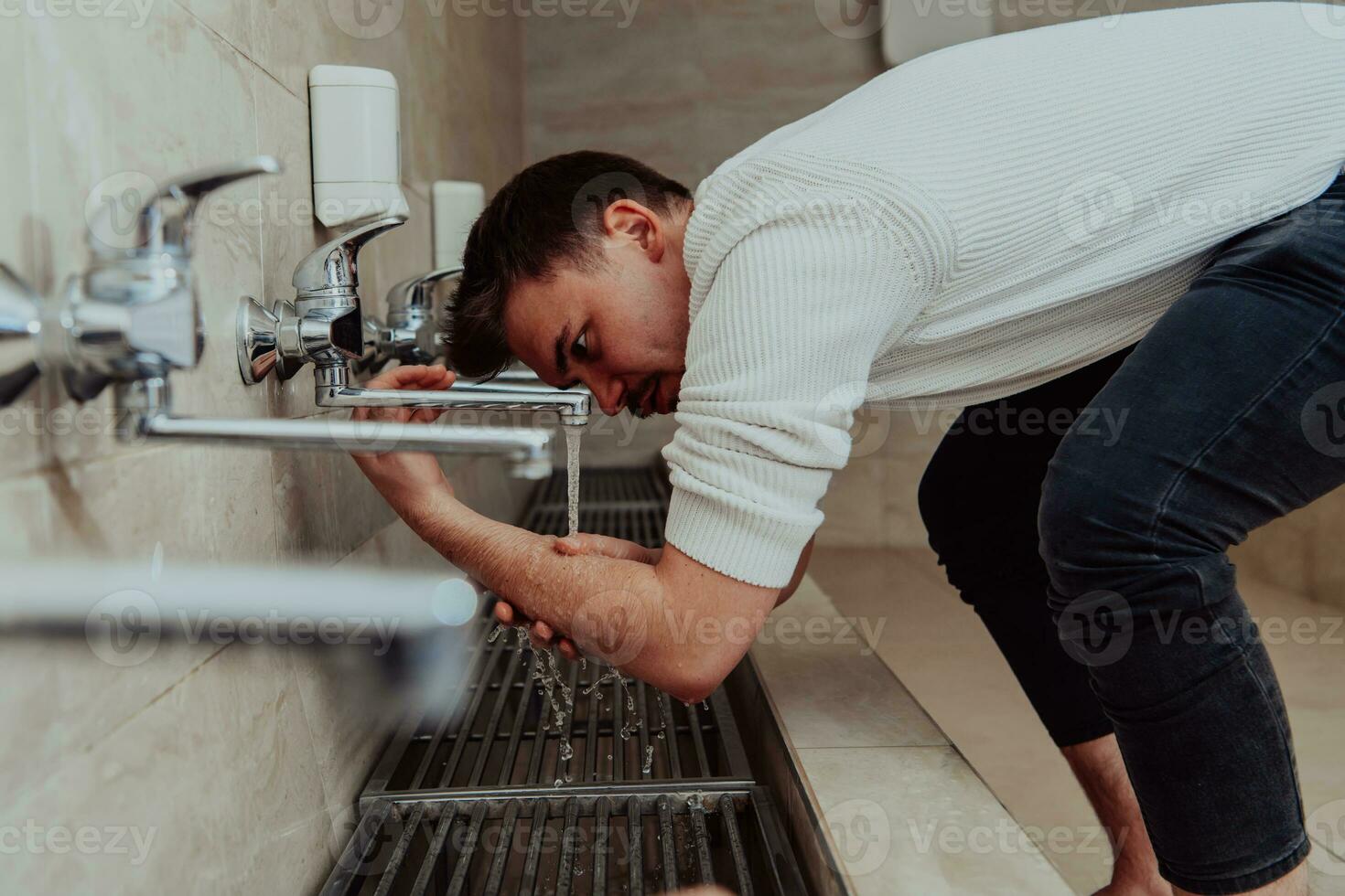 A Muslim performing ablution. Ritual religious cleansing of Muslims before performing prayer. The process of cleansing the body before prayer photo