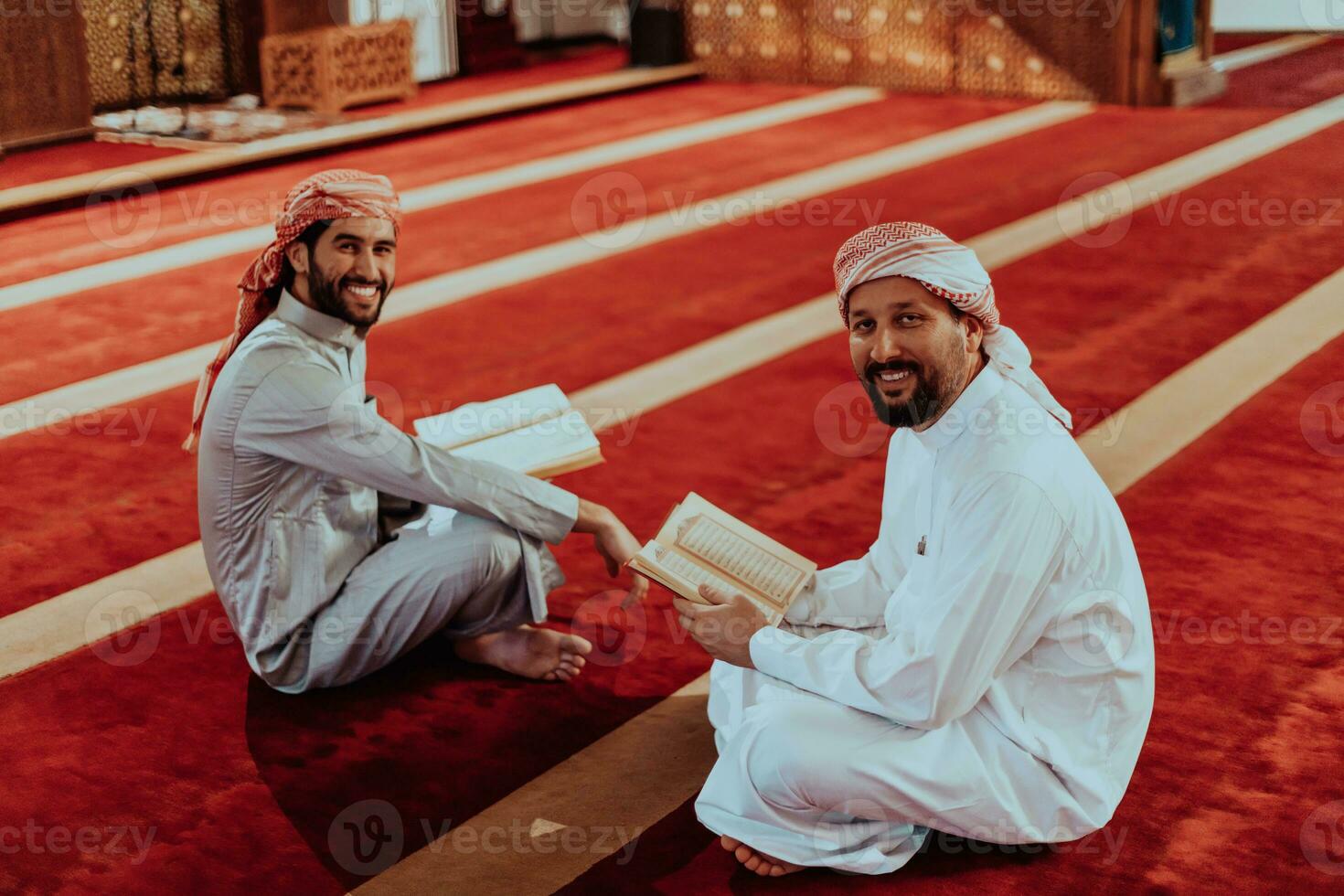 A group of Muslims reading the holy book of the Quran in a modern mosque during the Muslim holiday of Ramadan photo
