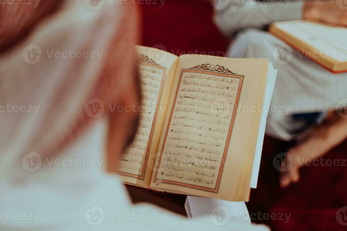A group of Muslims reading the holy book of the Quran in a modern mosque during the Muslim holiday of Ramadan photo