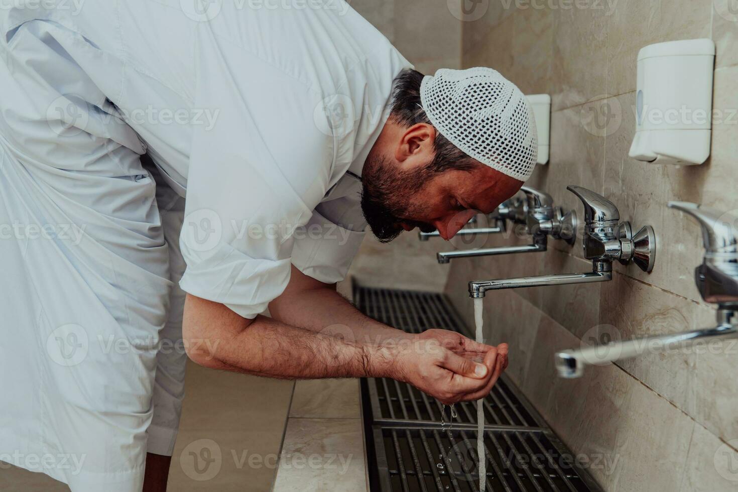 A Muslim performing ablution. Ritual religious cleansing of Muslims before performing prayer. The process of cleansing the body before prayer photo