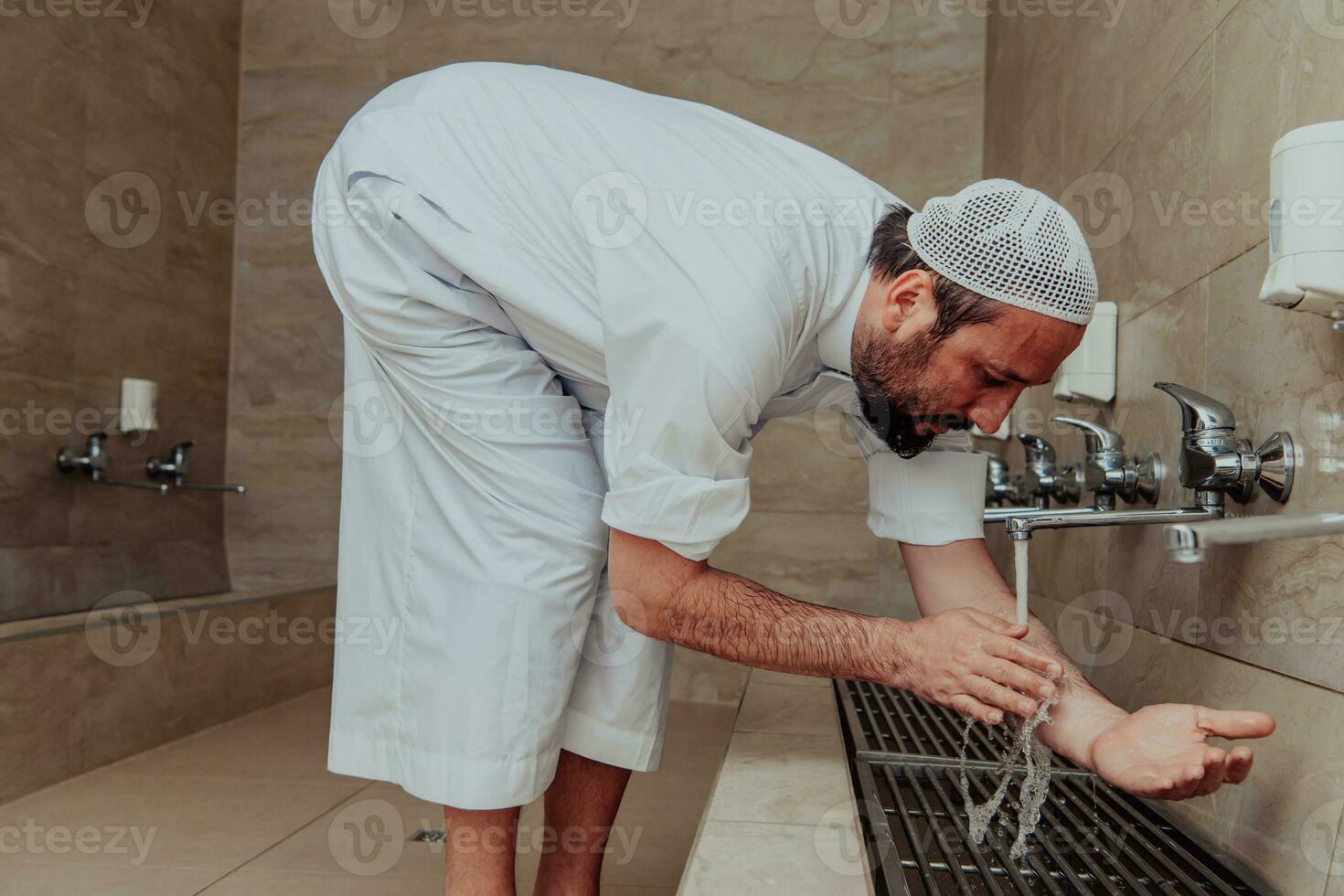 A Muslim performing ablution. Ritual religious cleansing of Muslims before performing prayer. The process of cleansing the body before prayer photo