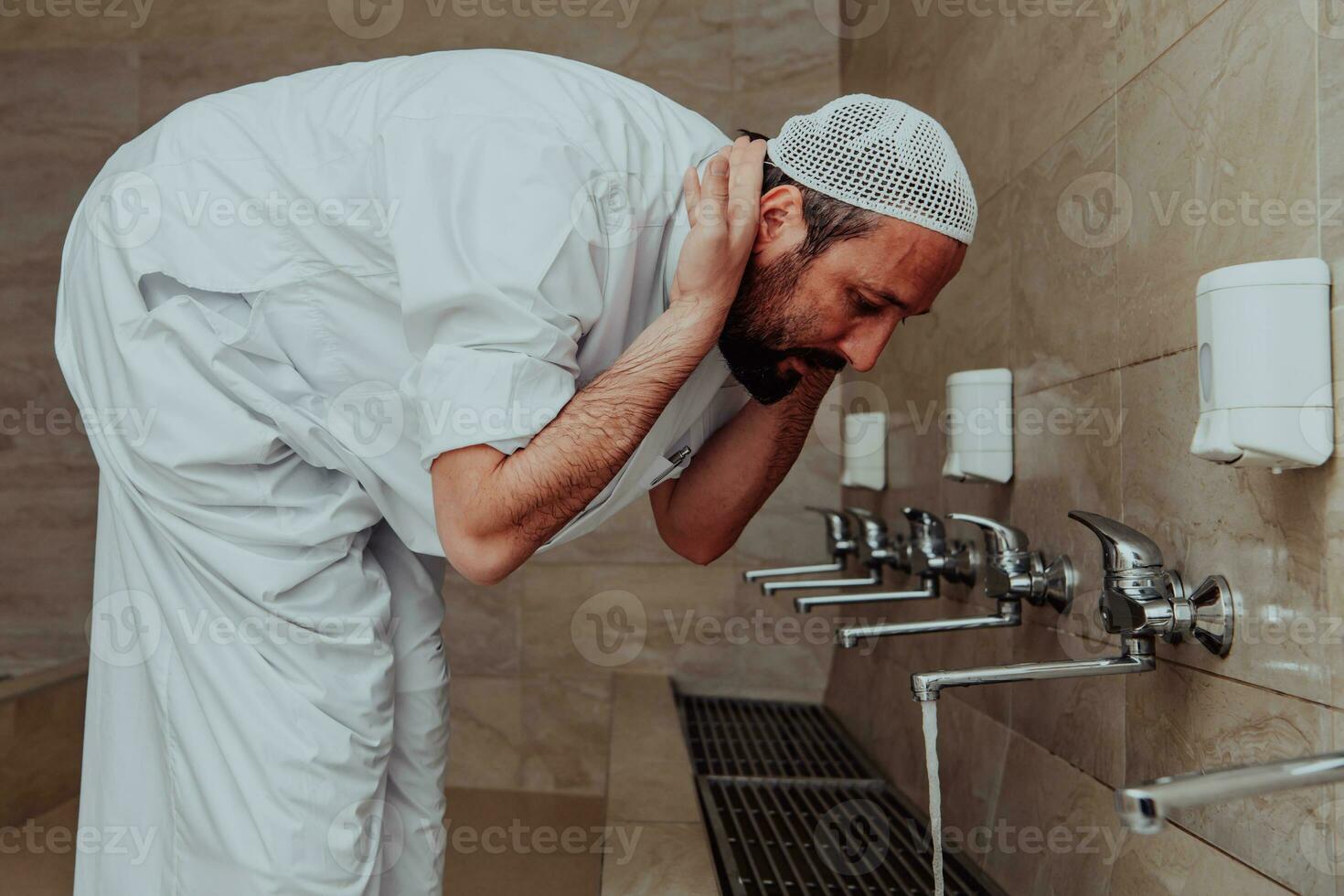 A Muslim performing ablution. Ritual religious cleansing of Muslims before performing prayer. The process of cleansing the body before prayer photo