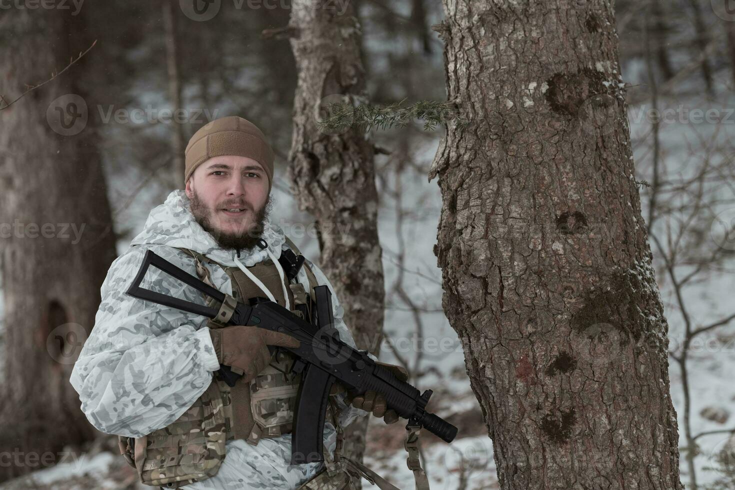 guerra de invierno en las montañas árticas. operación en condiciones frías. soldado en uniforme camuflado de invierno en el ejército de guerra moderno en un día de nieve en el campo de batalla del bosque con un rifle. enfoque selectivo foto