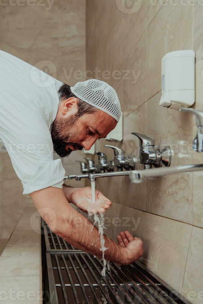 A Muslim performing ablution. Ritual religious cleansing of Muslims before performing prayer. The process of cleansing the body before prayer photo
