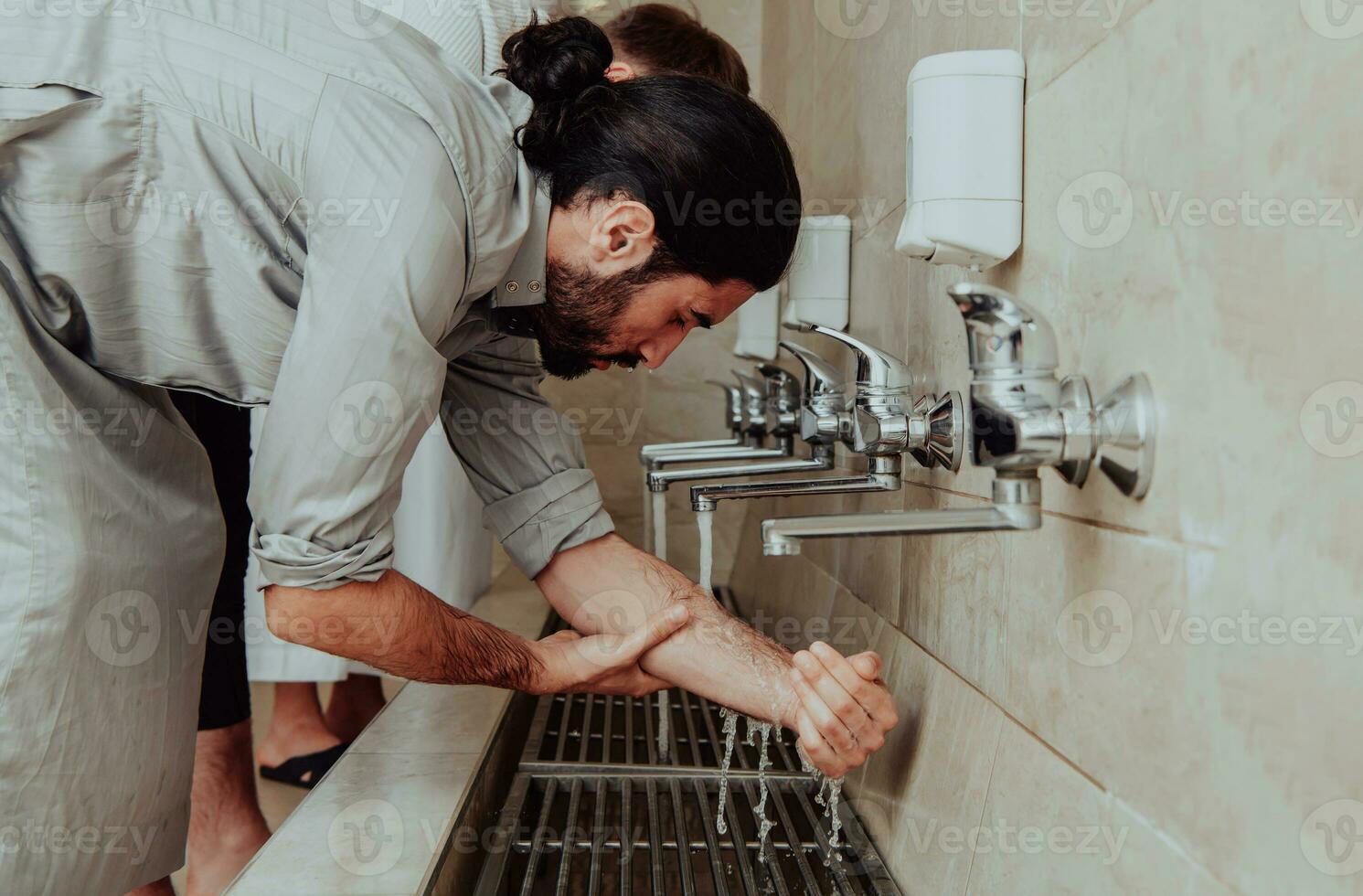 A Muslim performing ablution. Ritual religious cleansing of Muslims before performing prayer. The process of cleansing the body before prayer photo