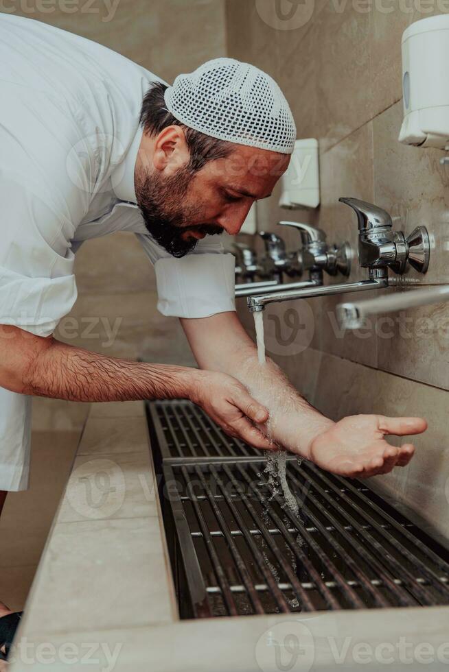 A Muslim performing ablution. Ritual religious cleansing of Muslims before performing prayer. The process of cleansing the body before prayer photo