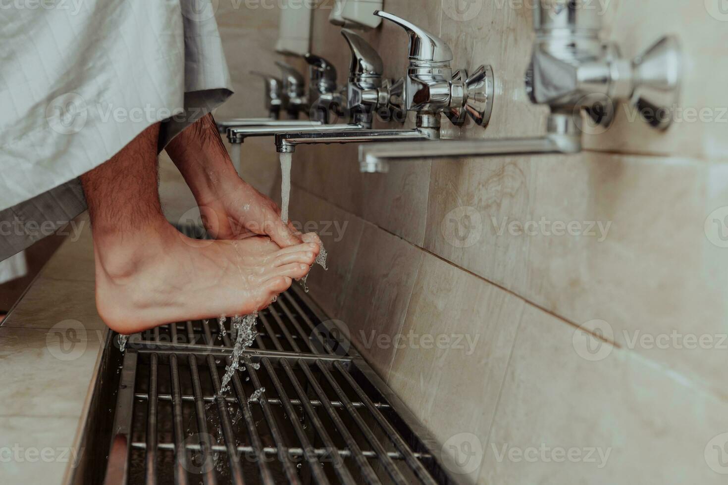 A Muslim performing ablution. Ritual religious cleansing of Muslims before performing prayer. The process of cleansing the body before prayer photo