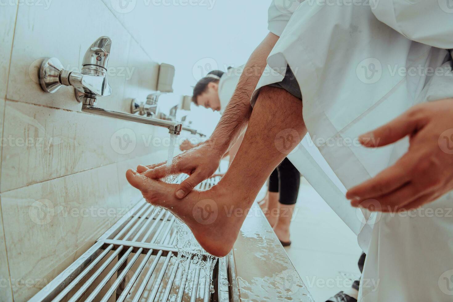 A Muslim performing ablution. Ritual religious cleansing of Muslims before performing prayer. The process of cleansing the body before prayer photo