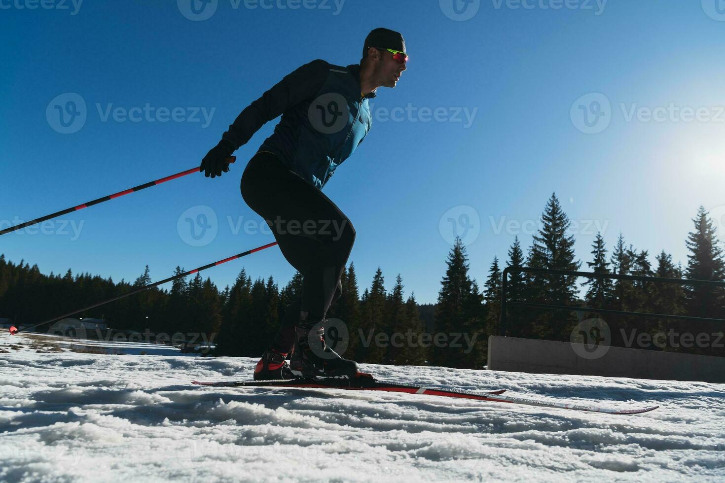 Nordic skiing or Cross-country skiing classic technique practiced by man in a beautiful panoramic trail at morning. photo