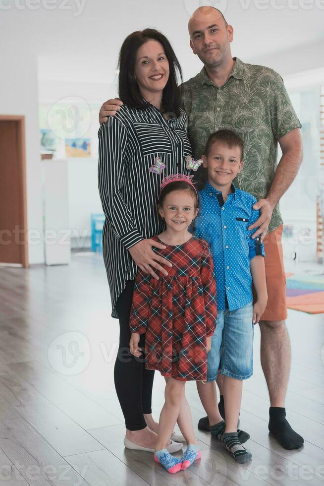 Portrait of a happy family. Photo of parents with children in a modern preschool classroom. Selective focus