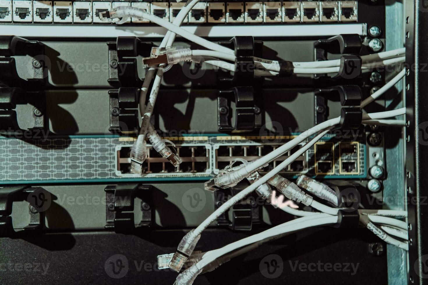 Close up of technician setting up network in server room photo