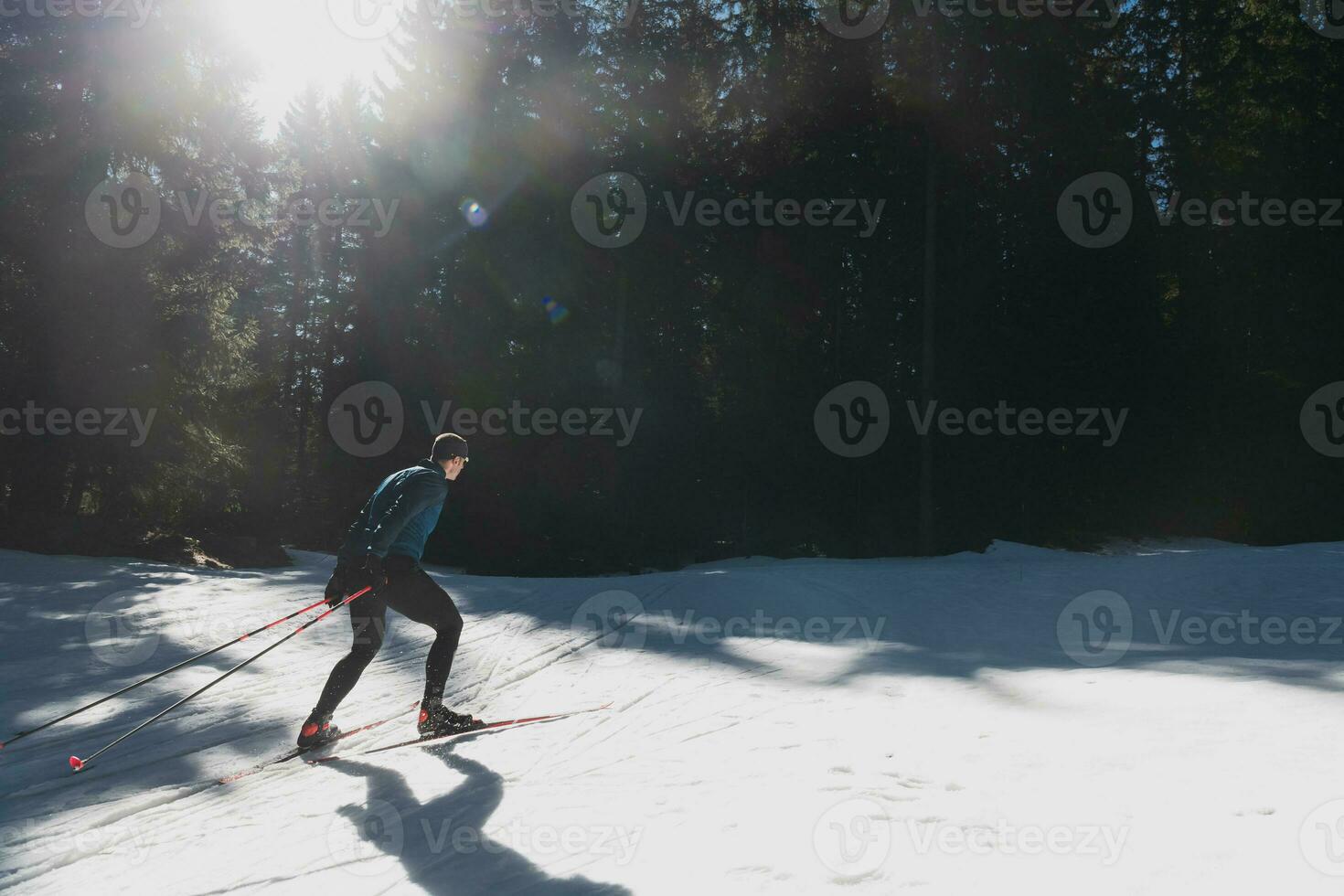 Nordic skiing or Cross-country skiing classic technique practiced by man in a beautiful panoramic trail at morning. photo