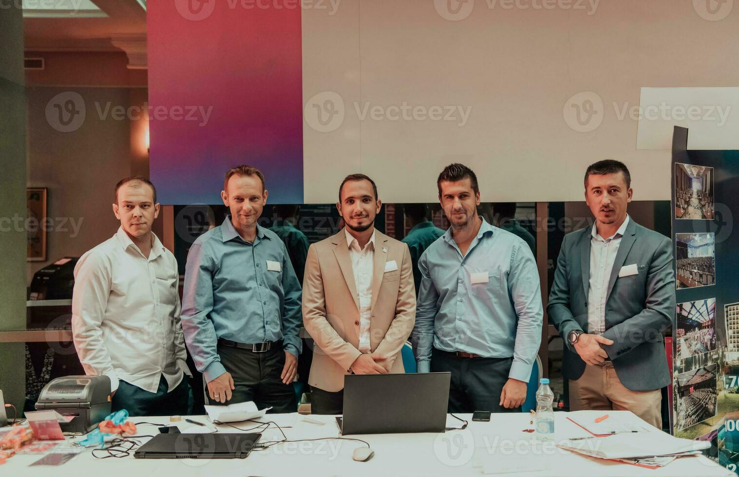 A group of businessmen ready to present a project in a large conference hall photo