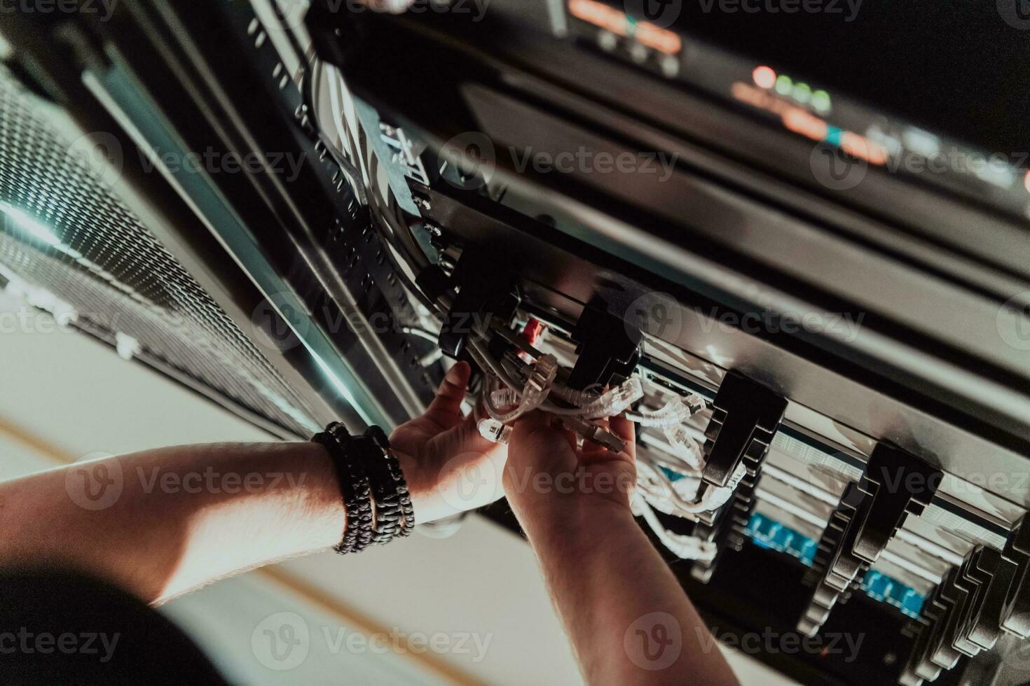 Close up of technician setting up network in server room photo