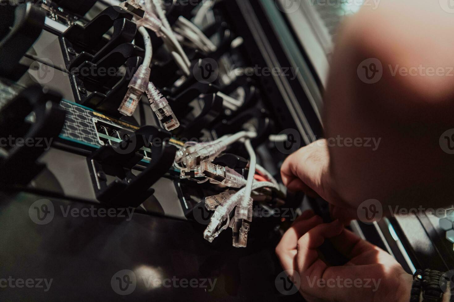 Close up of technician setting up network in server room photo