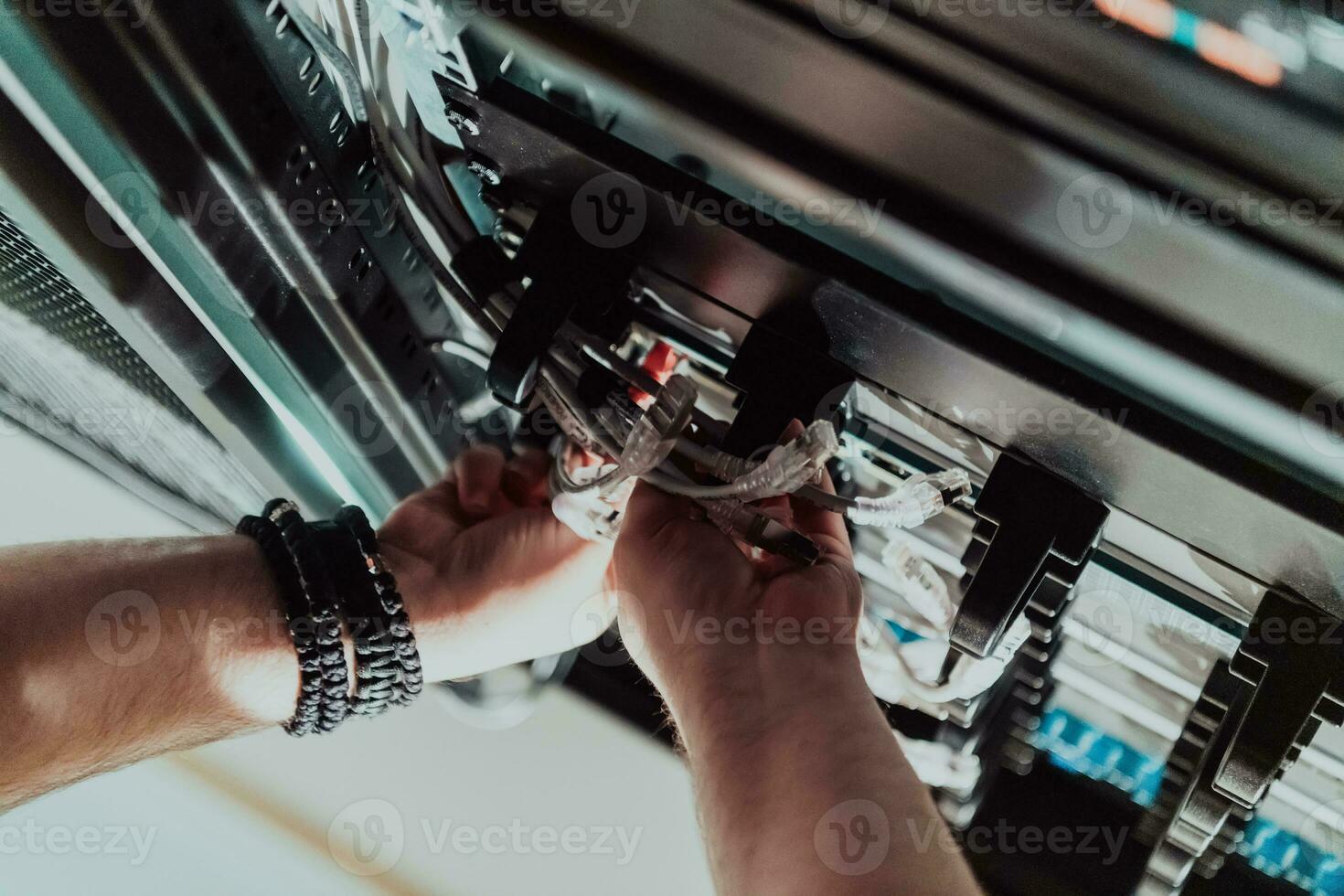 Close up of technician setting up network in server room photo