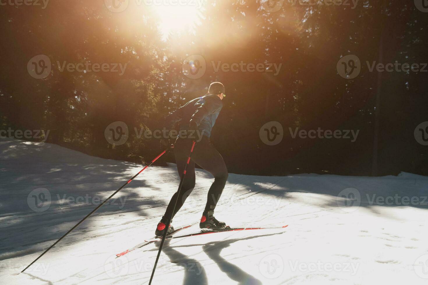 Nordic skiing or Cross-country skiing classic technique practiced by man in a beautiful panoramic trail at morning. photo