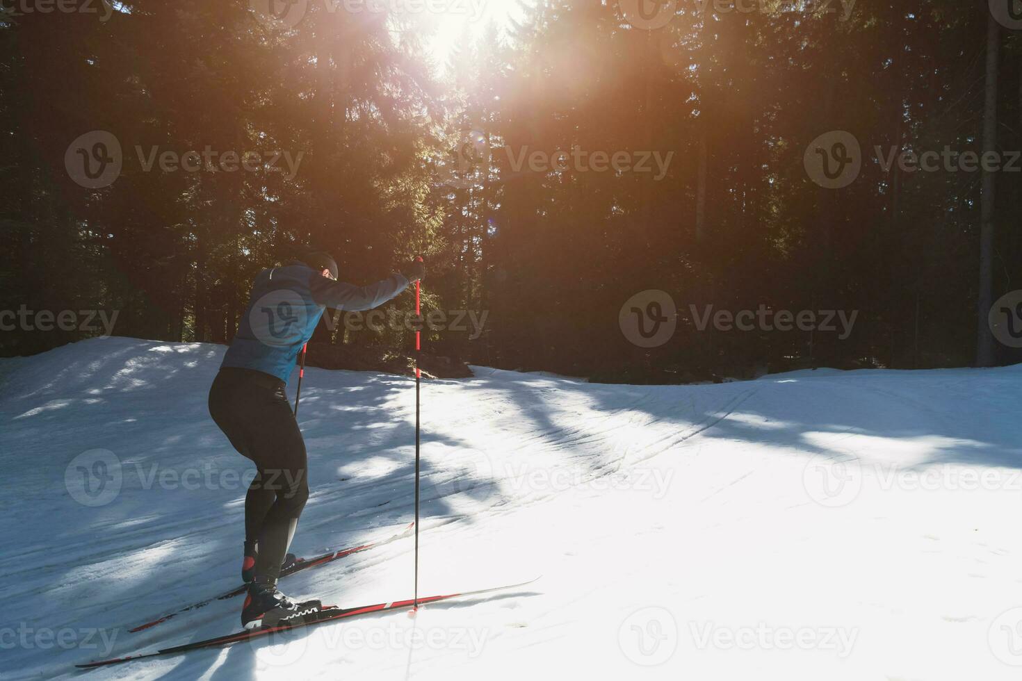 Nordic skiing or Cross-country skiing classic technique practiced by man in a beautiful panoramic trail at morning. photo