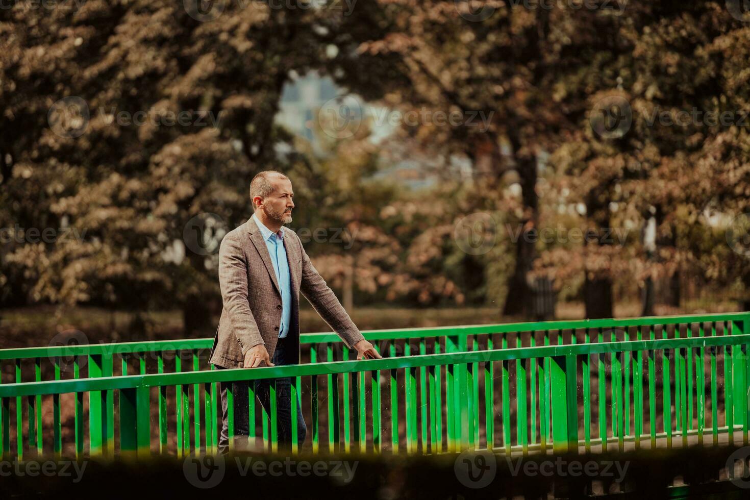 focused businessman in suit walking in urban environment. photo
