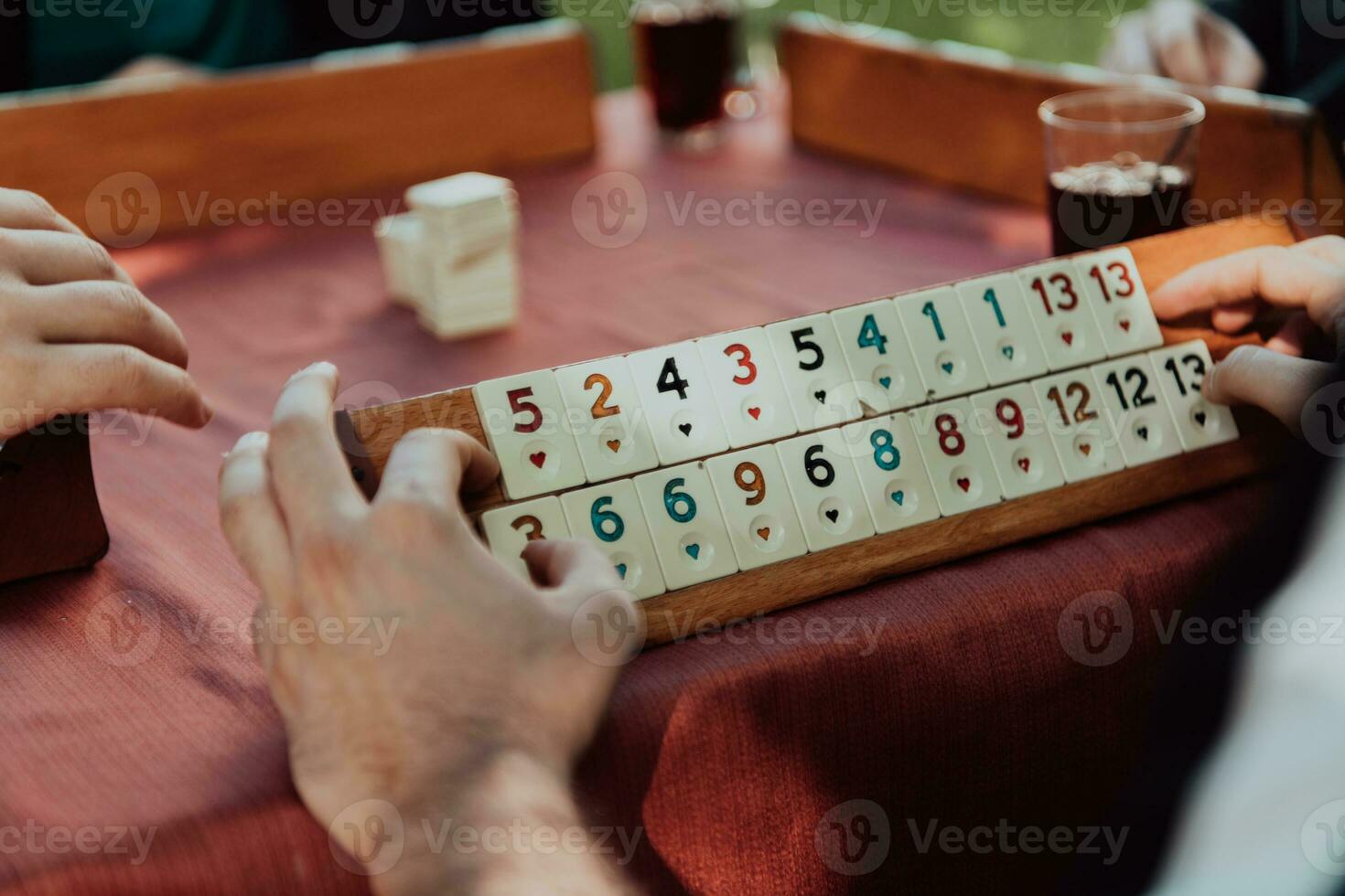 A group of men drink traditional Turkish tea and play a Turkish game called Okey photo