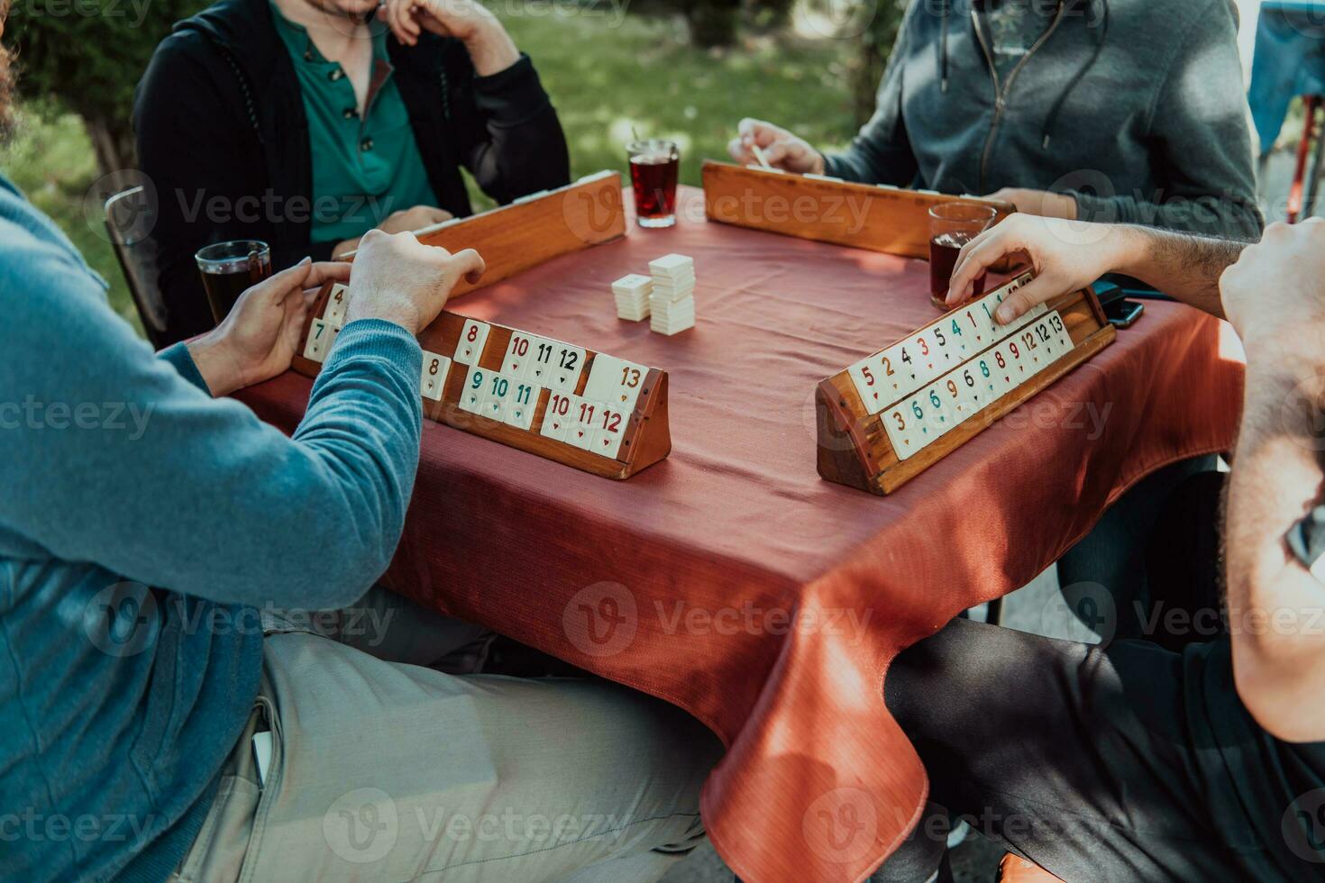 A group of men drink traditional Turkish tea and play a Turkish game called Okey photo