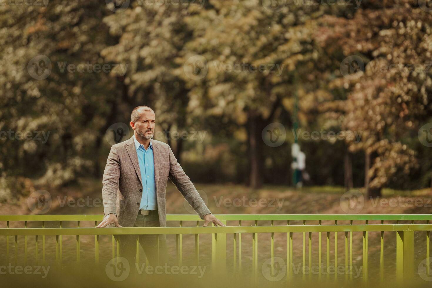 focused businessman in suit walking in urban environment. photo